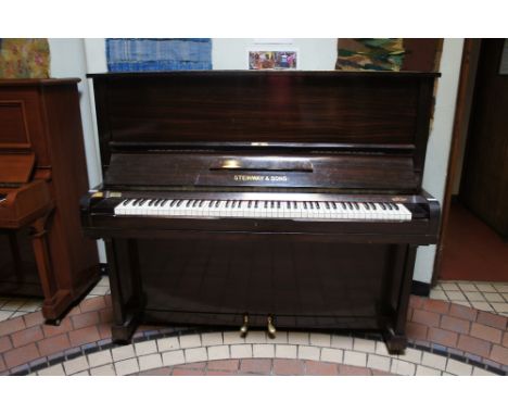 Steinway (c1908) 
A Model K upright piano in a satin mahogany case.