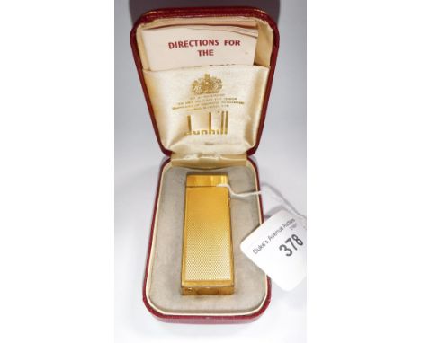DUNHILL: A YELLOW METAL CIGARETTE LIGHTER in a fitted Dunhill presentation case