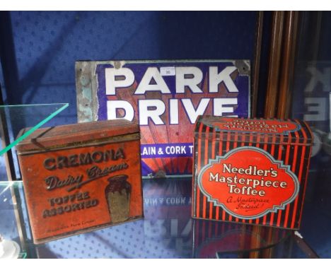  A VINTAGE 'PARK DRIVE' ENAMEL SIGN, a 1920s 'Cremona' Dairy Cream toffee tin and a similar 'Needler's' toffee tin (3)