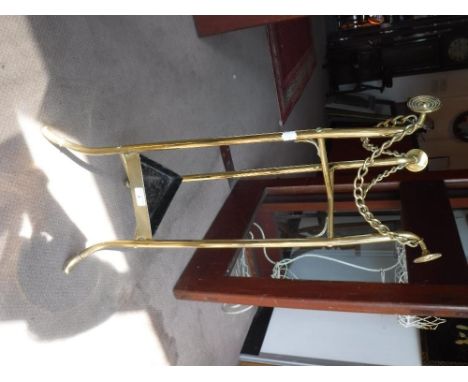 A VICTORIAN BRASS STICK-STAND of triangular form, with brass chained sides, 30" high