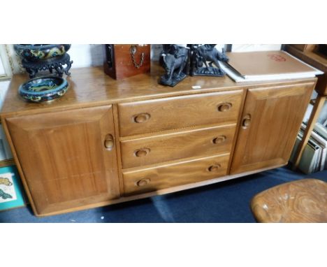 ERCOL: A PALE ELM SIDEBOARD with fitted central cutlery drawer, 61" wide