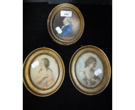 A GEORGE III PAINTED PORTRAIT MINIATURE ON PAPER of a gentleman in profile and two other similar prints each in oval gilt fra