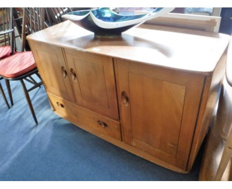 ERCOL: A PALE ELM SIDEBOARD fitted cupboards and a drawer, 45" wide