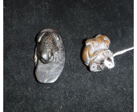 A JAPANESE CARVED WOOD NETSUKE in the form of a monkey and one other in the form of a toad seated on a sandal
