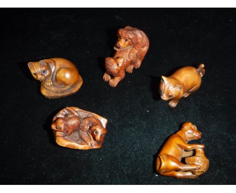 A COLLECTION OF JAPANESE CARVED WOOD NETSUKE in the form of dogs and cats (5)