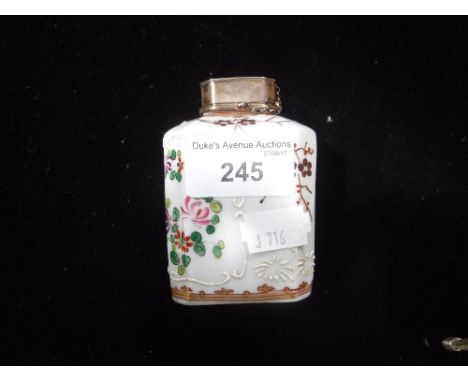 A SAMPSON PORCELAIN TEA CADDY with a silver plated cover and polychrome painted flower and armorial decoration, late 19th/ear