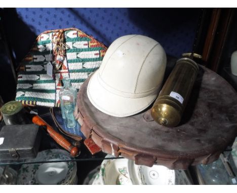 A VINTAGE (MILITARY?) CAMPAIGN BRASS WASHBOWL with a fitted leather top, a vintage crash helmet, brass fire extinguisher and 