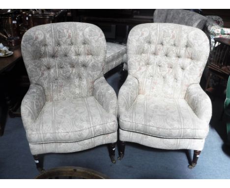 A PAIR OF BUTTON BACK VICTORIAN STYLE ARMCHAIRS upholstered in cream material