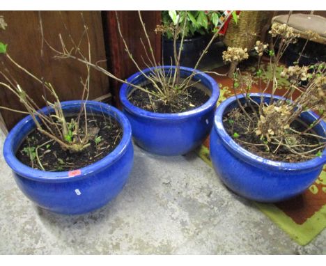 A set of three large blue glazed plant pots 30cm h x 49cm d Location: G 