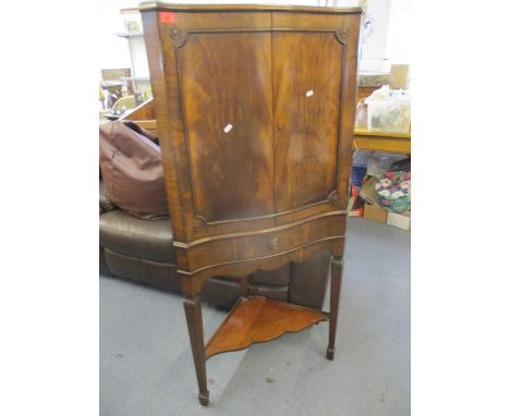 A reproduction mahogany corner unit having a shelf below on tapering legs, 148 h x 70cm w 