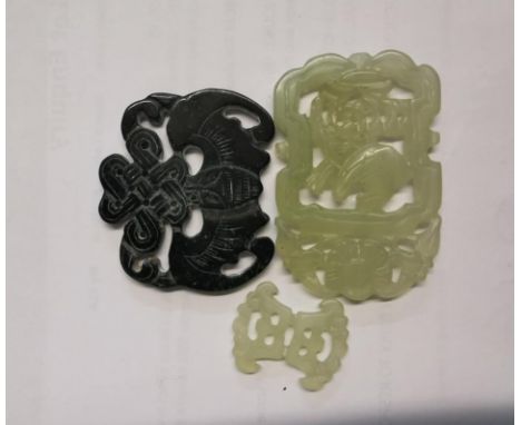 A group of three carved and pierced jade pendants, to include one spinach jade one modelled as a bat, largest 6 cm wideLocati