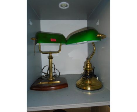 A brass effect Bankers light with green glass shade, and a similar desk lamp mounted on a wooden base Location: LWB 