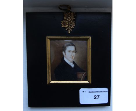 Early 19th century miniature portrait, seated Gentleman in blue coat, ebonised frame,marked W M  Mills verso