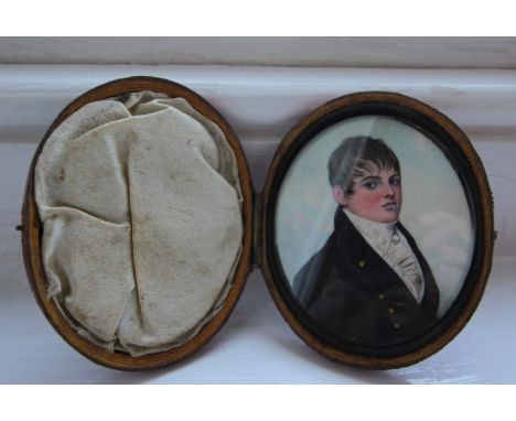 Early 19th century thought to be by Frederick Buck, miniature portrait of Young Gentleman in black coat, hinged red leather c