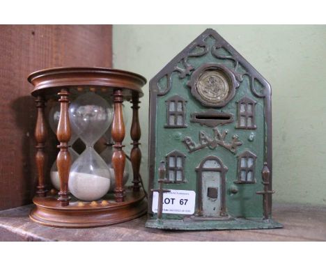 A vintage metal money bank, together with a replica of Mary Queen of Scots personal egg timer, from the example in the Britis