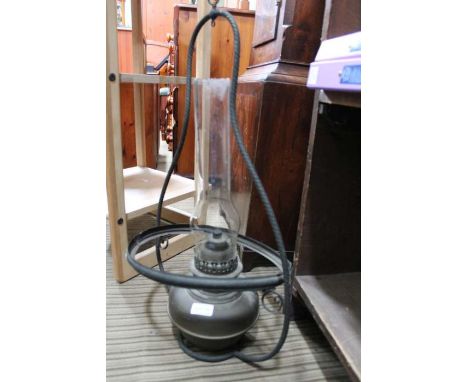 An original hanging brass based oil lamp and chimney.