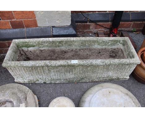 A reconstituted stone planter, 92cm x 25cm x 25cm