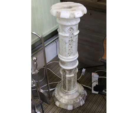 A calved Onyx display pedestal having internal lamp 