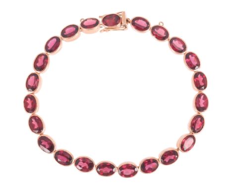 A 9ct rose gold garnet tennis line bracelet, maker YVE?, London 2004, rub-over set with oval mixed-cut garnets, band width 5.