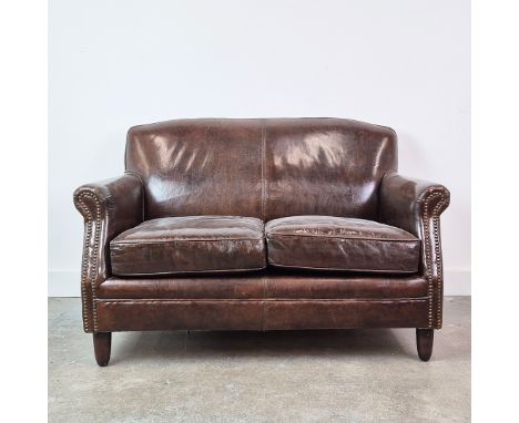 CLUB SOFA. Two seater in close nailed brown leather, 79cm H x 124cm W x 79cm D.