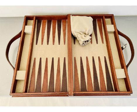 TRAVELLING BACKGAMMON SET. tan leathered case, 23cm W x 40cm D x 7cm H.