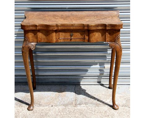 A George II style walnut fold-over card table retailed by Harrods, 81cm (32 ins) wide.Condition ReportSmall losses to veneer 