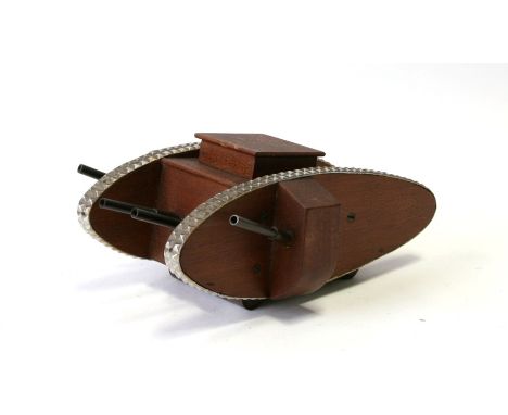 A WW1 trench art Tank Money Box made of wood with aluminium tracks and metal machine guns, mounted on metal roller wheels. Ov
