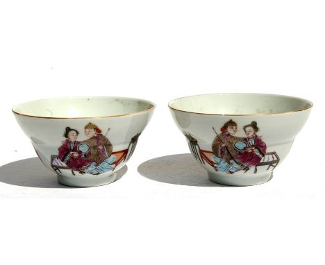 A pair of Chinese famille rose tea bowls decorated with figures, red seal mark to the underside, 10cms (4ins) diameter.Condit