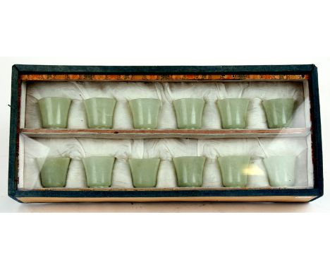A cased set of twelve Chinese jade like cups with D &amp; S Howlett collection label to the underside, each 4cms (1.5ins) hig