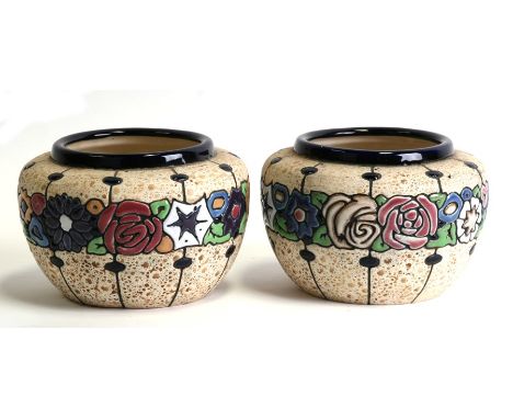 A pair of amphora vases decorated with flowers in enamel colours, 18cms (7ins) diameter.