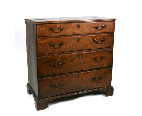 An early 19th century oak chest of four long graduated drawers, on bracket feet, 97cms (38ins) wide.Condition ReportDrawers o
