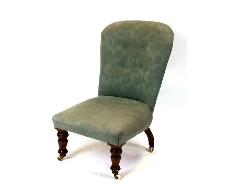 A button backed upholstered chair.