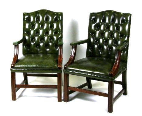 A pair of green leather button backed Georgian style office desk chairs.Condition ReportMinor scuffs and nicks, otherwise goo