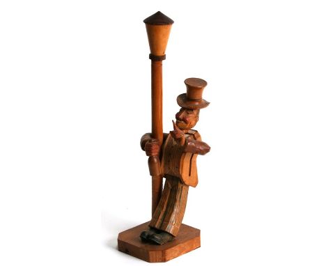 An Anri carved wooden novelty bottle opener modelled as a drunken man holding onto a lamp post, 30cms (11.75ins) high.