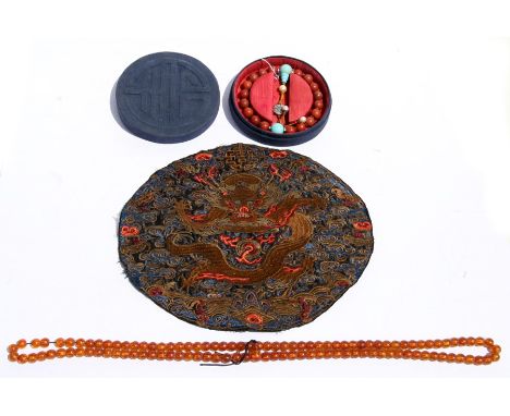 A Chinese hardstone bead bracelet; together with a string of amber like beads and a Chinese silk embroidered panel depicting 