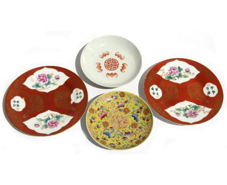 A pair of Chinese Republic style plates decorated with flowers and calligraphy on a red ground with gilt highlights, 18cms (7
