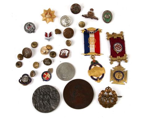 A quantity of enamel badges, medals and buttons.