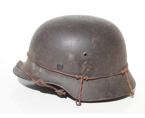 A WW2 Third Reich helmet with liner and chin strap. Marked inside SE66 &amp; 4704