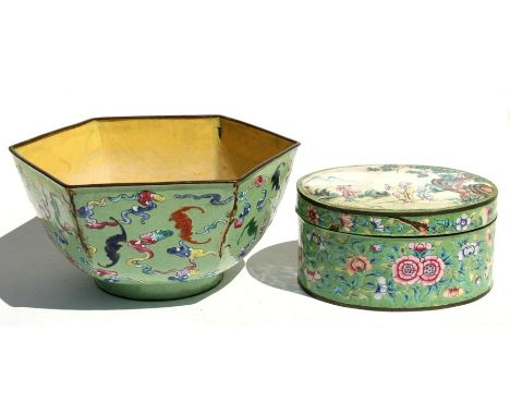 A Chinese enamel bowl of hexagonal form decorated with bats on a green ground, black seal mark to the underside, 20cms (8ins)