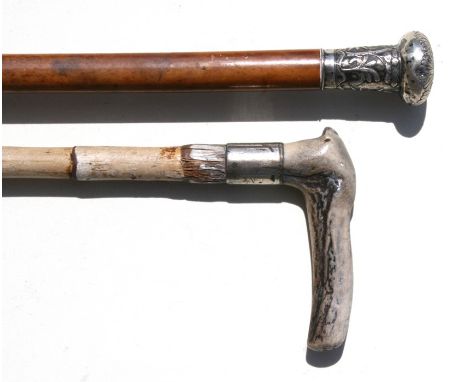 A Malacca walking stick with Chinese white metal handle; together with a bamboo walking stick with antler handle (2).