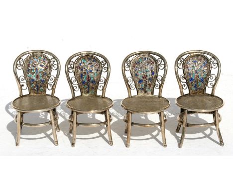 A set of four Chinese white metal (silver) and enamel miniature chairs with two character mark to the back, 5cms (2ins) high.