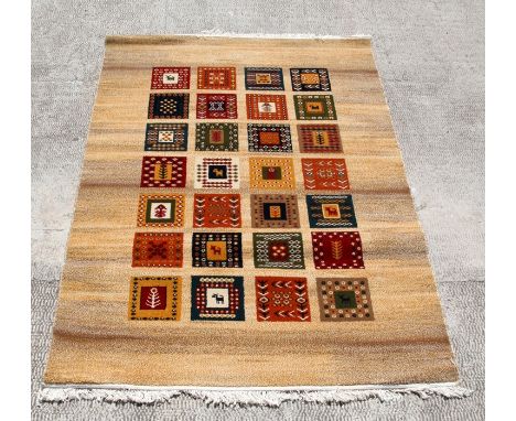 A modern Persian Golestan Collection rug with a panel design on a beige ground, 150 by 225cms (59 by 88.5ins).