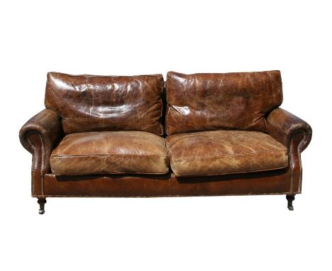 A modern distressed brown leather three seater sofa. 181cm (71.25 ins) wideCondition ReportDepth 82cms.