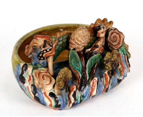 A Chinese pottery brush washer decorated with a dragon, bird and flowers, 20cms (8ins) wide.