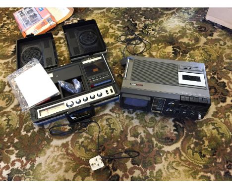 A portable tape and radio and a cassette deck with built in tv.