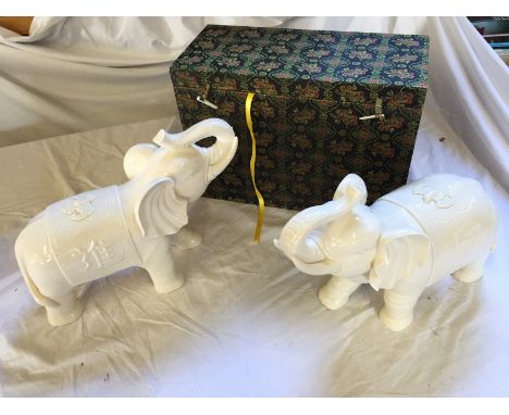 A pair of white ceramic elephants.