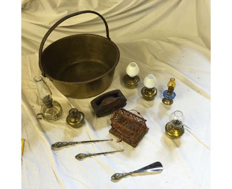 A brass jam pan, two button hooks, and a collection of lamps.