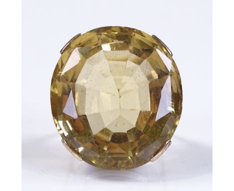 A large unmarked gold oval-cut citrine dress ring, citrine length 28.4mm, size G, 18.9g 