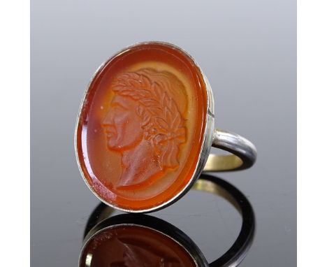 A silver-gilt relief carved carnelian seal ring, depicting male with wreath, setting height 20.8mm, size J, 3.2g 