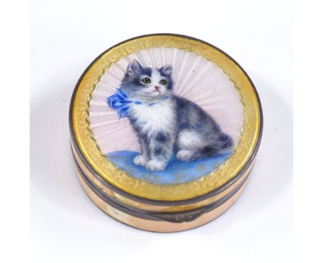 A small circular silver and yellow enamel compact, with kitten design lid and gilt interior, imported by PH Vogel &amp; Co, i